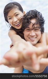 Man &amp; woman Asian couple, boyfriend girlfriend in bikini, taking vacation selfie photograph at the beach