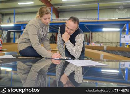 man and a woman discussing something in warehouse