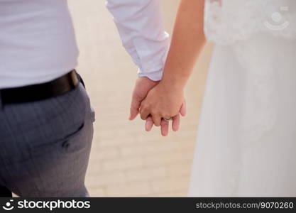 man and a woman hold hands at the wedding of newlyweds. a man and a woman hold hands at the wedding of newlyweds