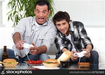 man and boy playing to video games