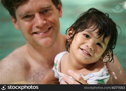 Man and child in swimming pool