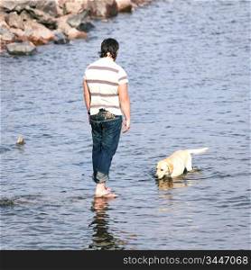 man and dog in water