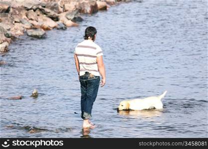 man and dog in water