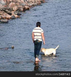 man and dog in water