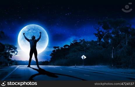 Man and full moon. Young screaming man at night with big full moon at background