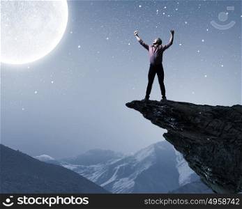 Man and full moon. Young screaming man at night with big full moon at background