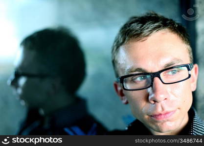 man and his reflection in glass