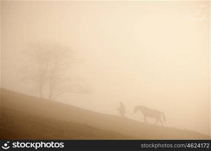 Man and horse silhouette on the hill. Carpathain mountains, Ukraine