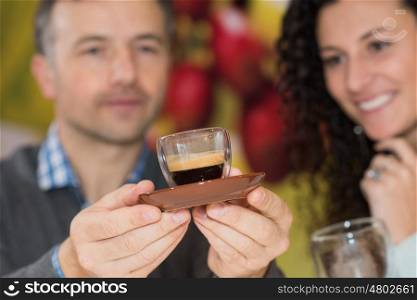 Man and lady examining espresso