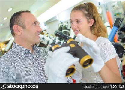 Man and lady holding binoculars in gloved hands