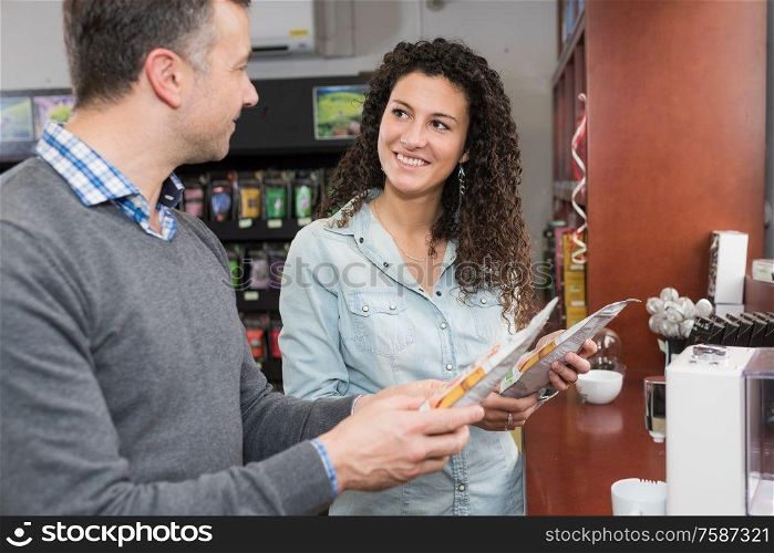 Man and lady looking at coffee pods