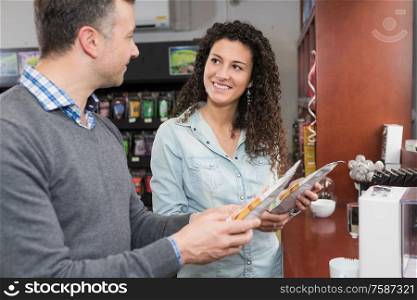 Man and lady looking at coffee pods