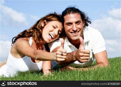 Man and lady showing thumbs-up at camera