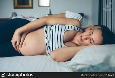 Man and pregnant woman sleeping in bed. Man and pregnant woman sleeping