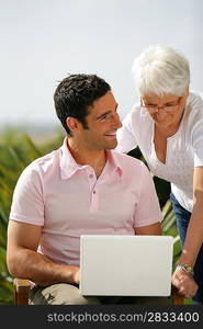 Man and senior woman with a laptop