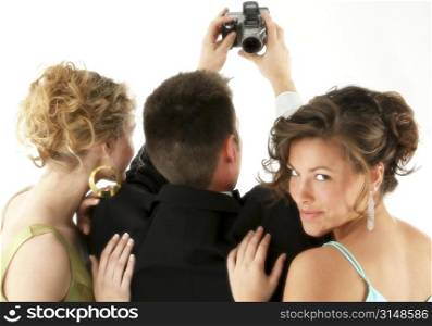 Man and two beautiful woman taking photo with digital camera.