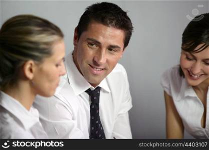 Man and two women in business meeting