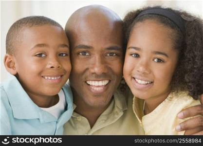 Man and two young children embracing and smiling