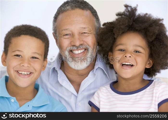 Man and two young children smiling