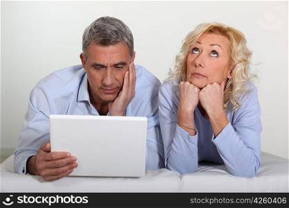 Man and wife bored with computer