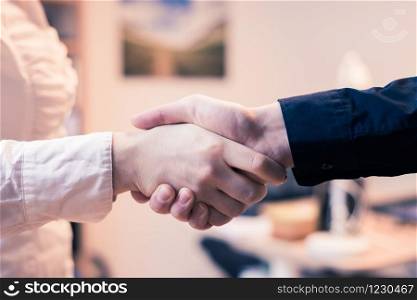 Man and woman are shaking hands, close up image, concept for human relationships