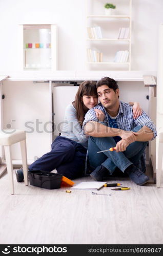 Man and woman assembling furniture at home