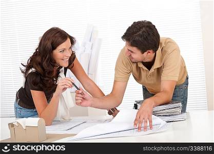 Man and woman at architect office working together