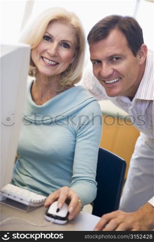 Man and woman at computer smiling (high key)