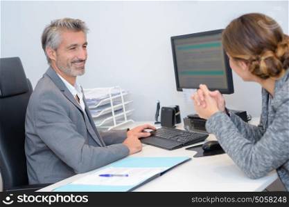 Man and woman at office desk