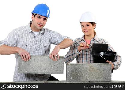 Man and woman building a house