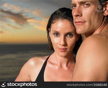 Man and woman by ocean at sunset close-up