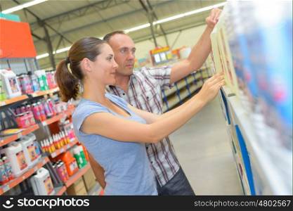 Man and woman choosing product from shelf