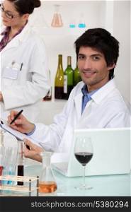 Man and woman conducting experiment on wine