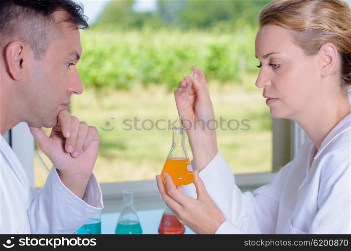 Man and woman conducting scientific experiment