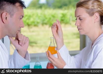 Man and woman conducting scientific experiment