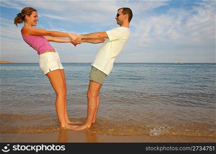Man and woman cost on a beach
