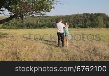 Man and woman dancing in the field