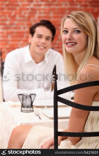 man and woman dining at a restaurant