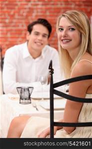 man and woman dining at a restaurant