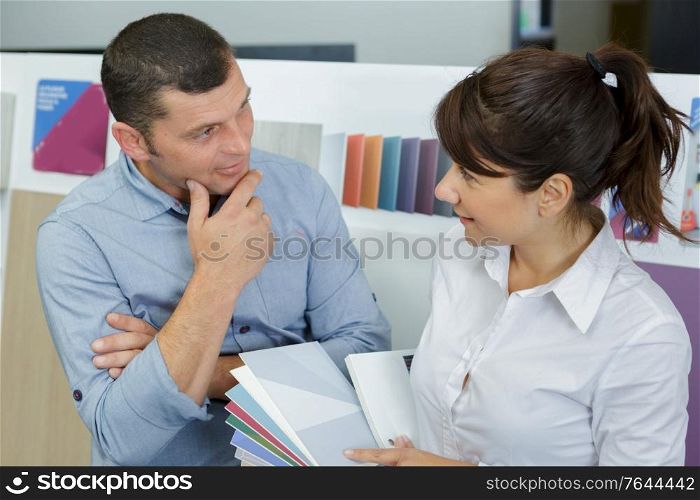 man and woman discussing new paint colors