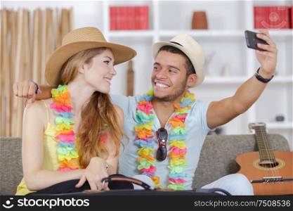 man and woman doing selfie before travelling