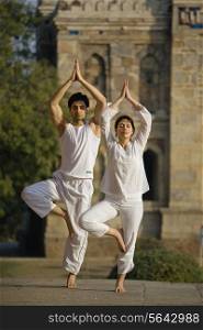 Man and woman doing Yoga