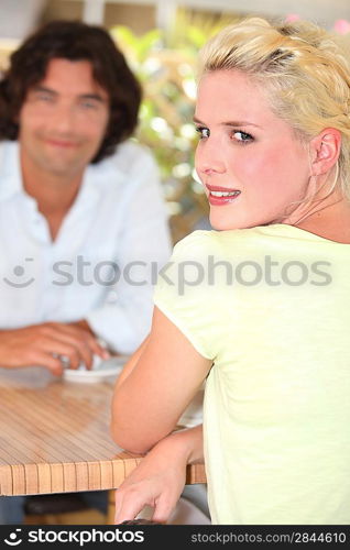 Man and woman enjoying coffee on terrace