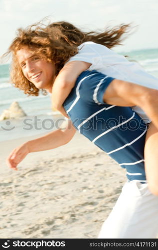 Man and woman enjoying vacations at beach