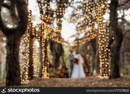 man and woman got engaged in autumn forest at wedding decorated ceremony
