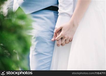 Man and woman hold hands close up. Hands of man and woman close up.. Man and woman hold hands close up