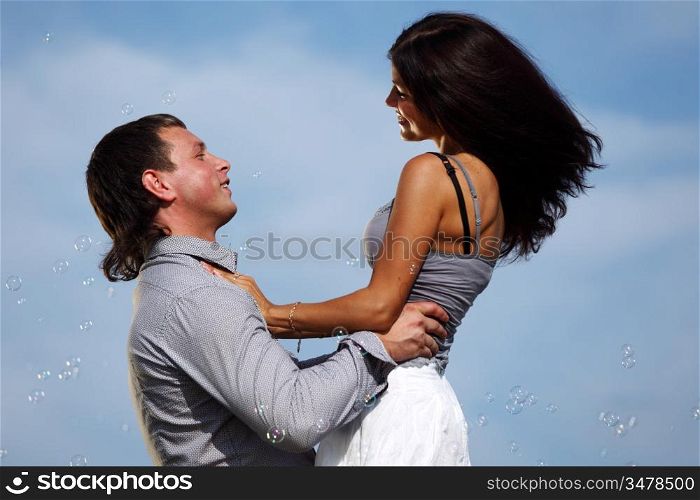 man and woman hug in the sky