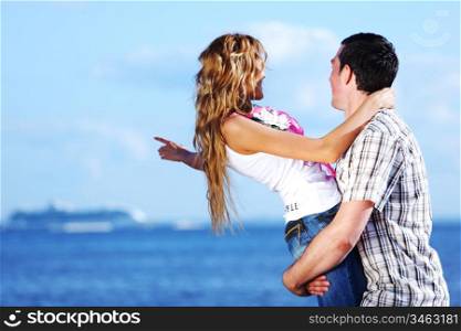man and woman hug in the sky and sea on sea