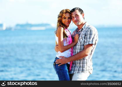 man and woman hug in the sky and sea on sea