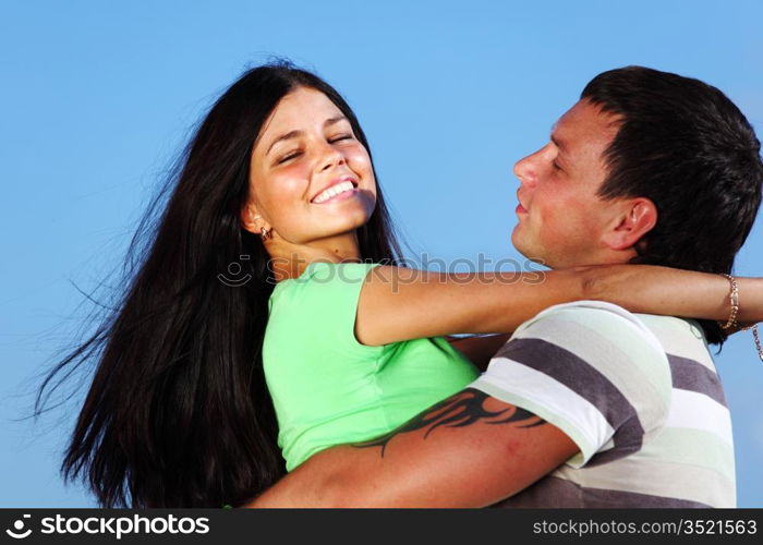 man and woman hug in the sky sea on background